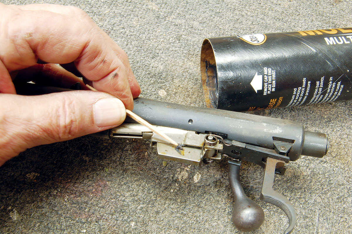 Lubing Grandpa’s Winchester M72 just like he did, using a toothpick and “tractor grease” (machinery grease).